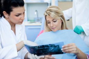 Female dentist showing patient her dental scan